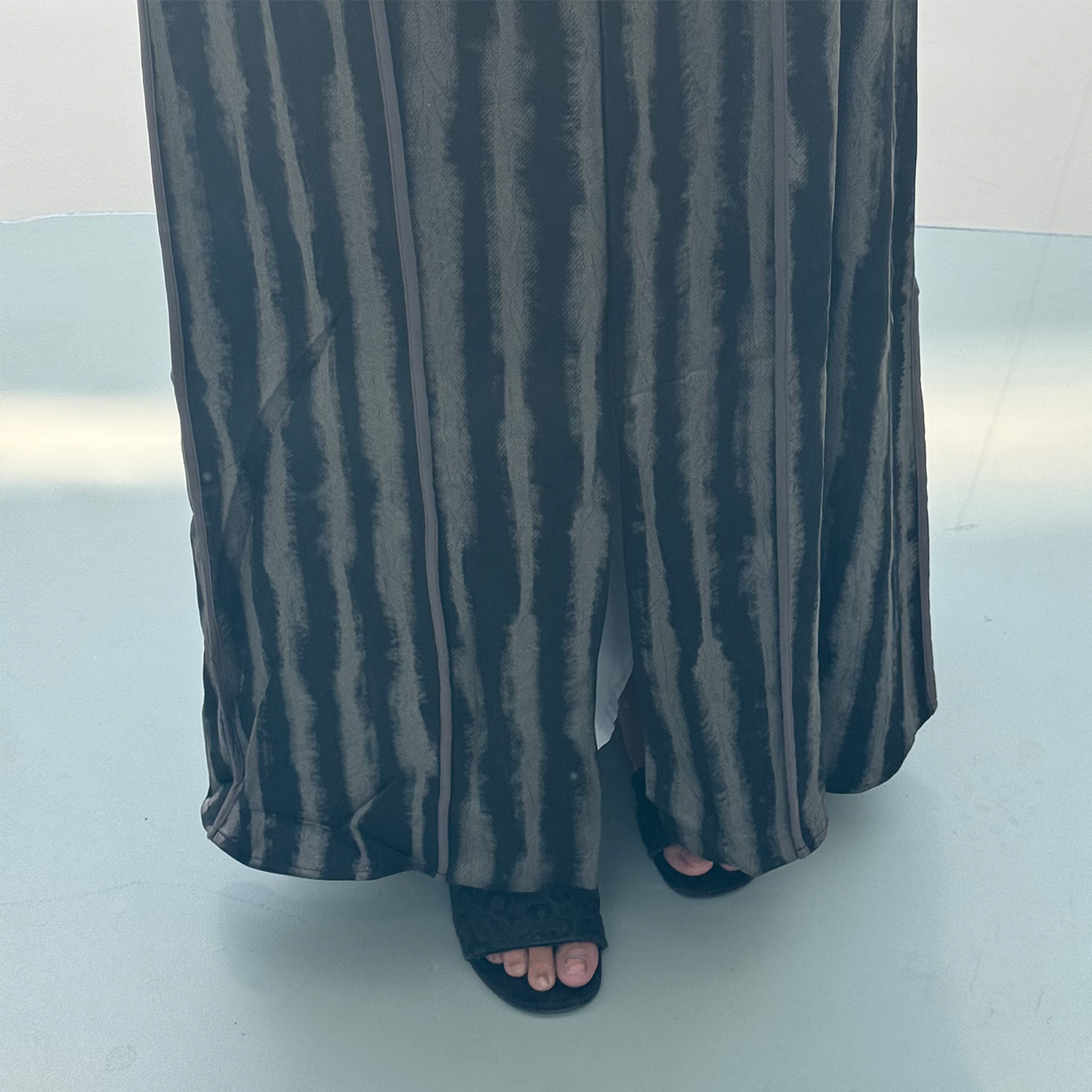 A black abaya with silver lines satan fabric