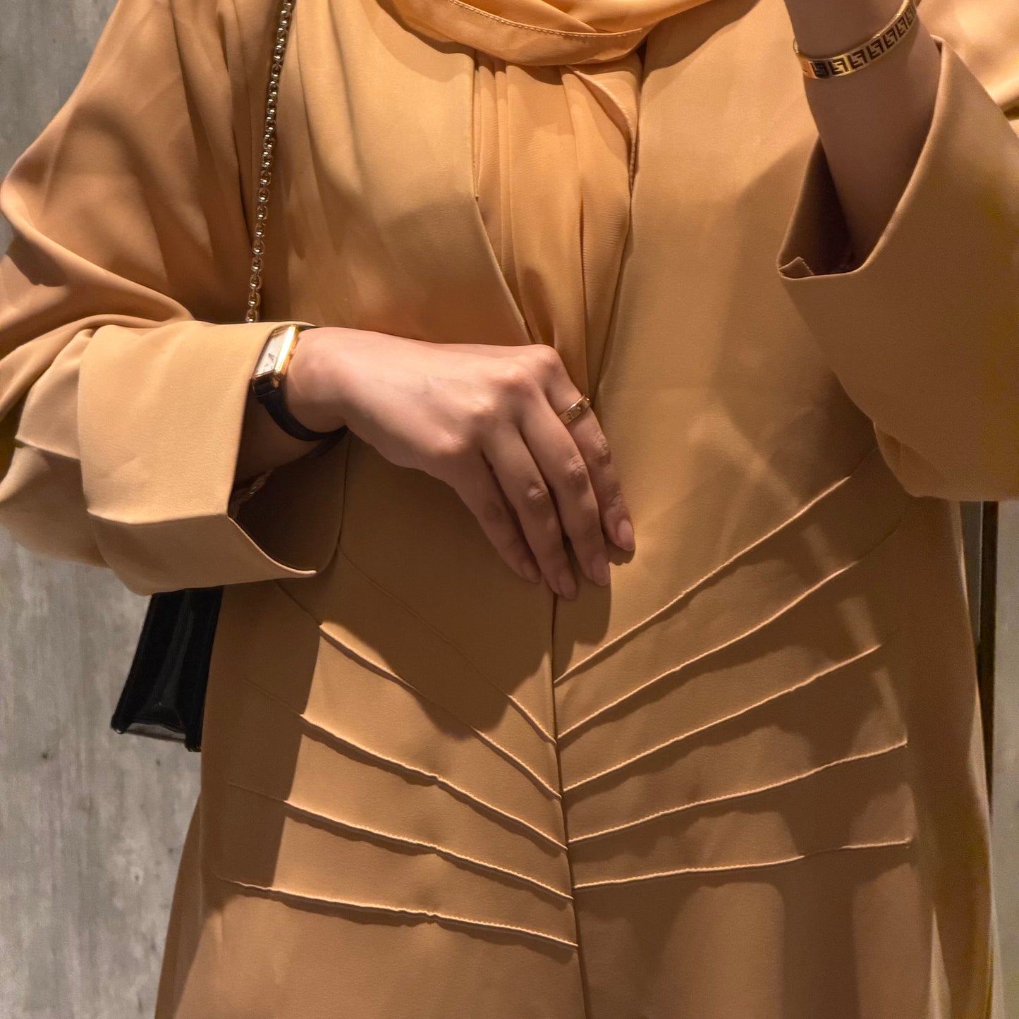 A peach abaya with nada fabric