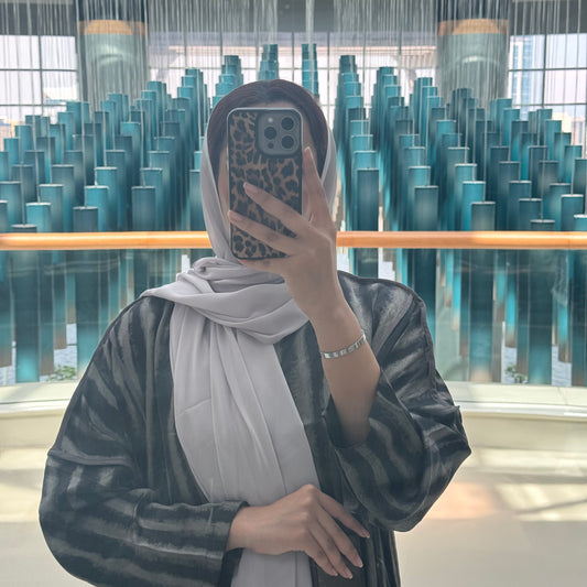 A black abaya with silver lines satan fabric