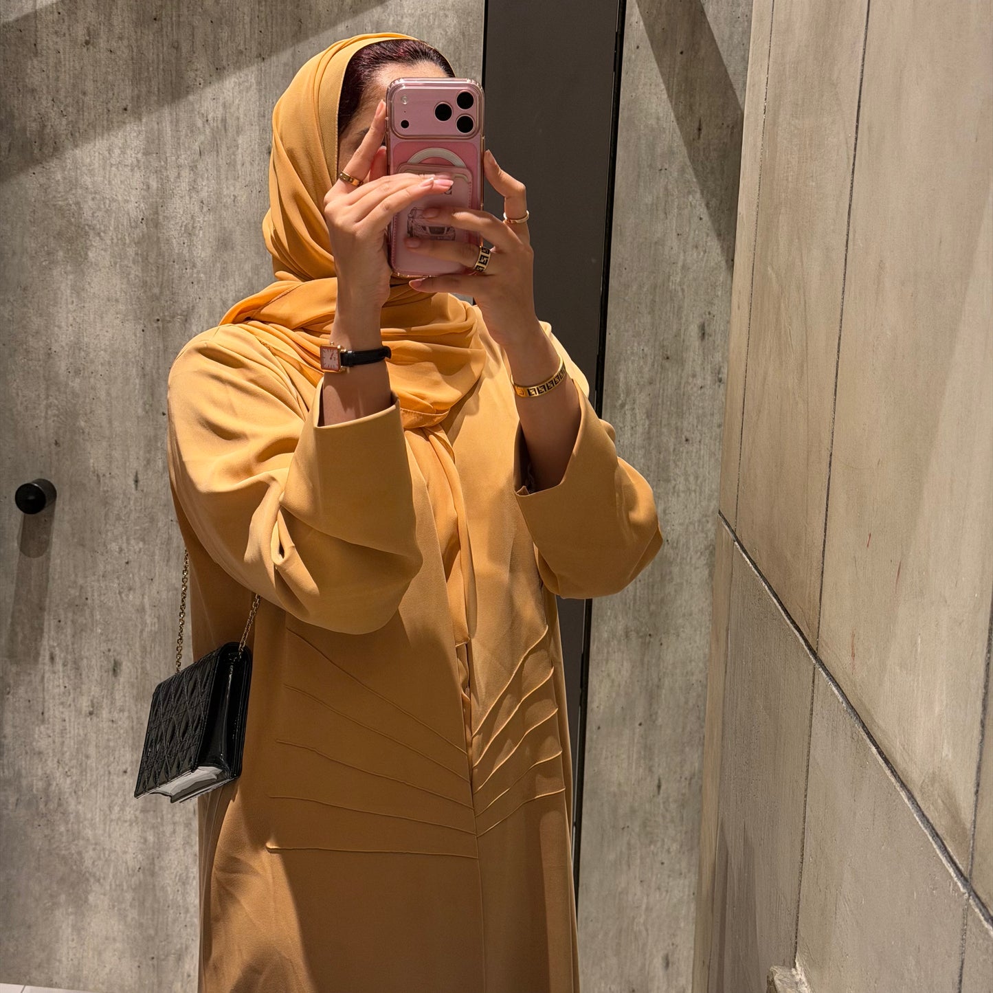 A peach abaya with nada fabric